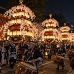 Illuminated flower-decorated lantern towers and drummers at Ikegami Oeshiki