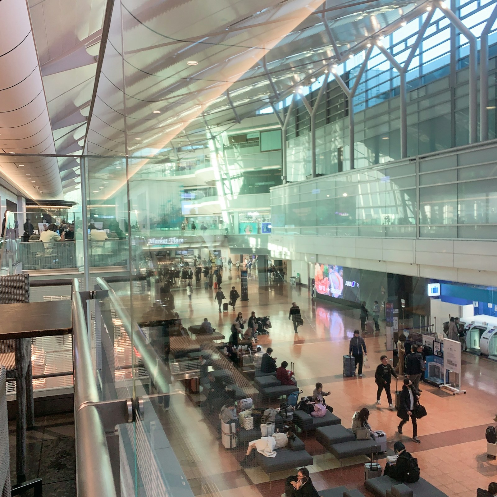 Travelers inside Haneda Airport terminal