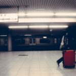 Traveler rolling a suitcase through Tokyo Station