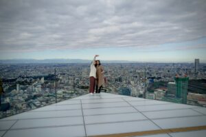 Visitors on the open-air SHIBUYA SKY rooftop overlooking Tokyo