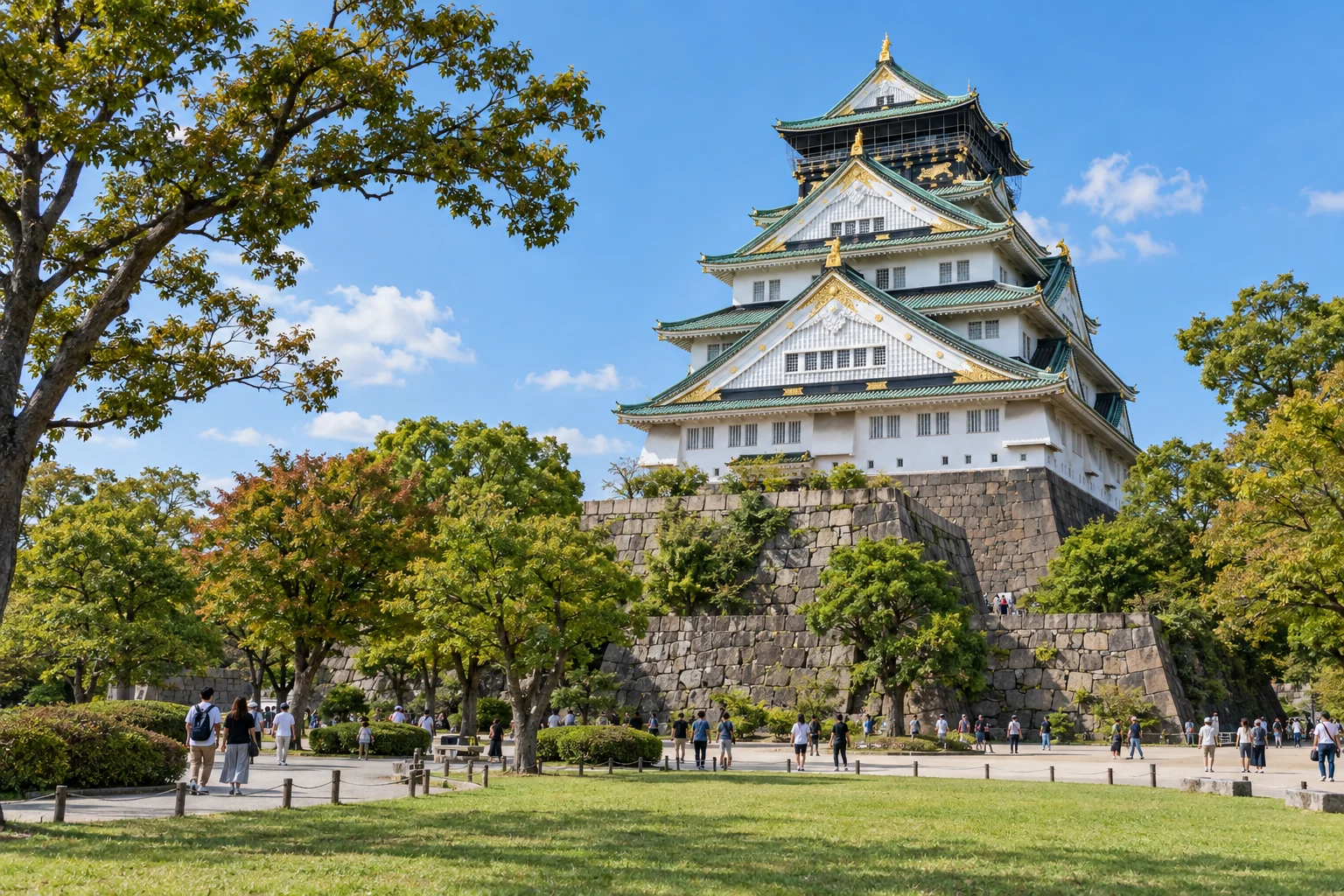 Osaka Castle rising above the trees and paths of Osaka Castle Park